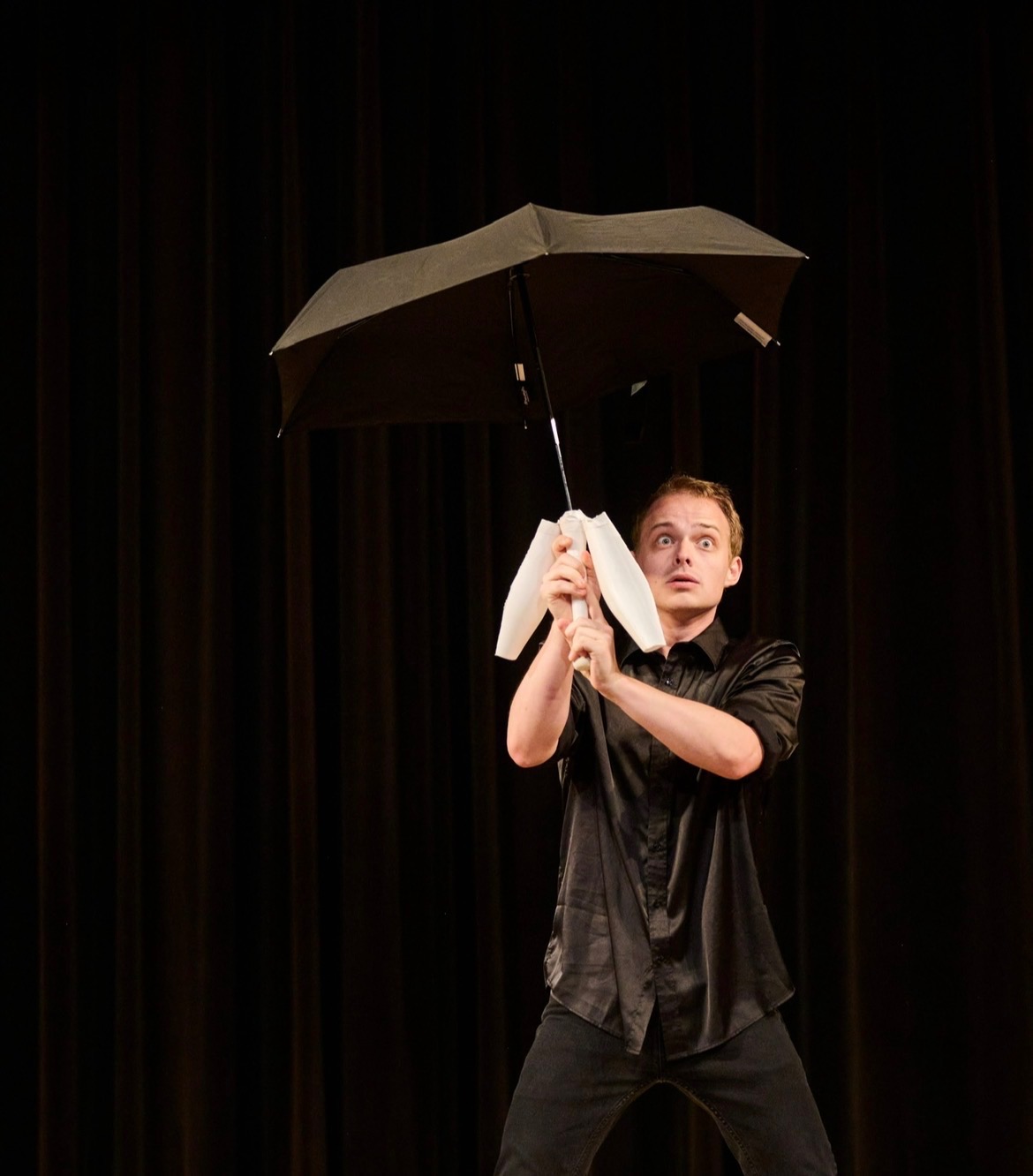 Zak McAllister holding an umbrella